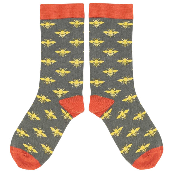 Gray socks with yellow bee pattern and red accents on a white background
