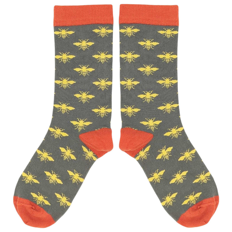 Gray socks with yellow bee pattern and red accents on a white background