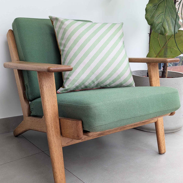 GREEN CUSHION ON CHAIR