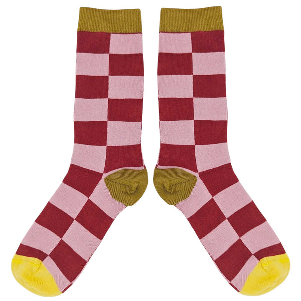 Checkered socks with red, pink, and yellow pattern on a white background