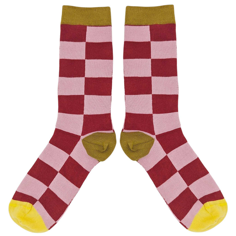 Checkered socks with red, pink, and yellow pattern on a white background