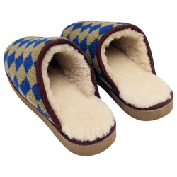 A pair of slip-on  catherine tough knit slippers with a blue and tan diamond pattern, featuring brown trim and a light beige footbed, shown against a plain white background.