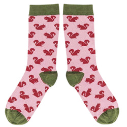 Pink socks with red squirrel pattern and green accents on a white background