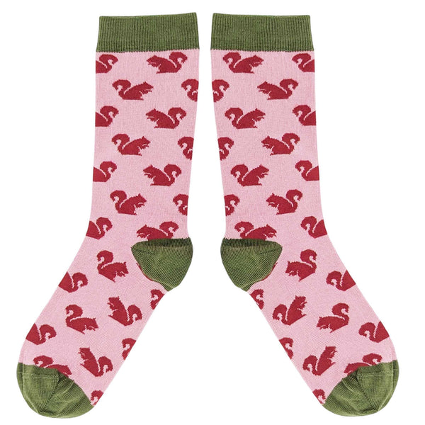 Pink socks with red squirrel pattern and green accents on a white background